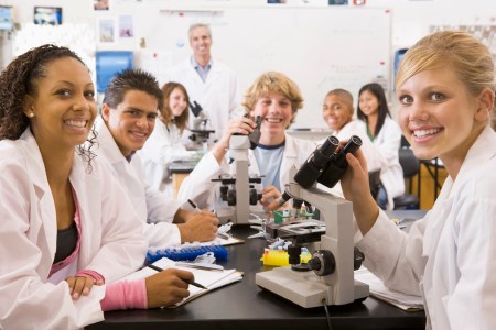 School children and their teacher in a high school science class